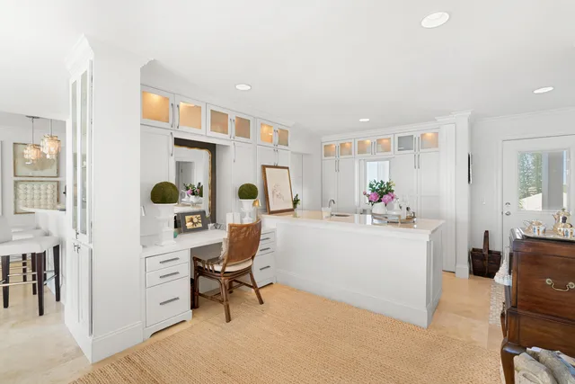 a kitchen with kitchen island granite countertop a white table and chairs