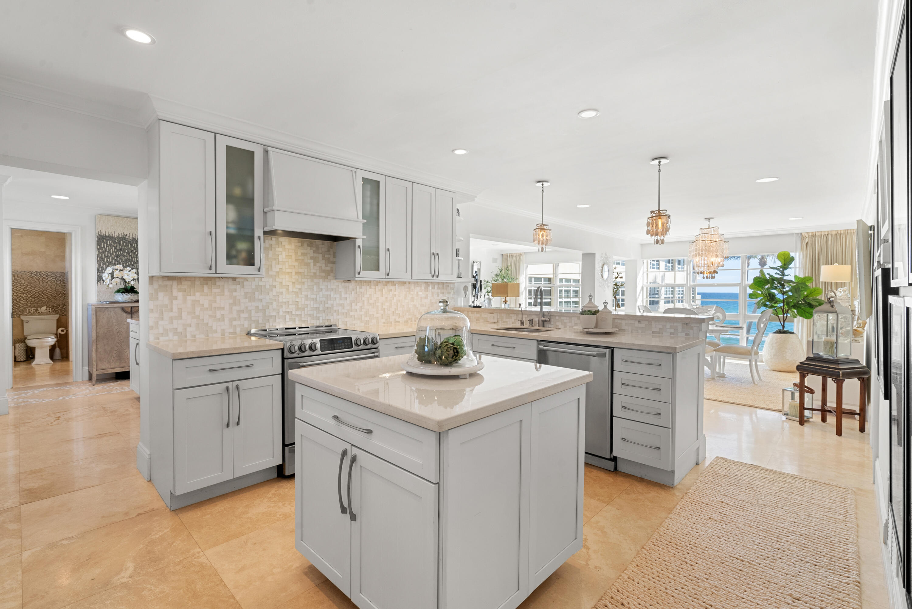 3851 North Ocean Boulevard, Unit 307308 Gulf Stream, FL 33483 - Photo 16 of 26 a kitchen with a sink stove and cabinets