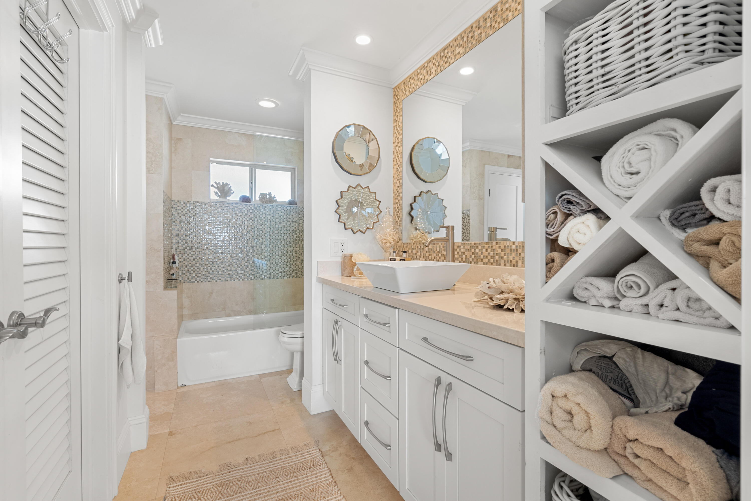 3851 North Ocean Boulevard, Unit 307308 Gulf Stream, FL 33483 - Photo 18 of 26 a bathroom with a tub sink and mirror