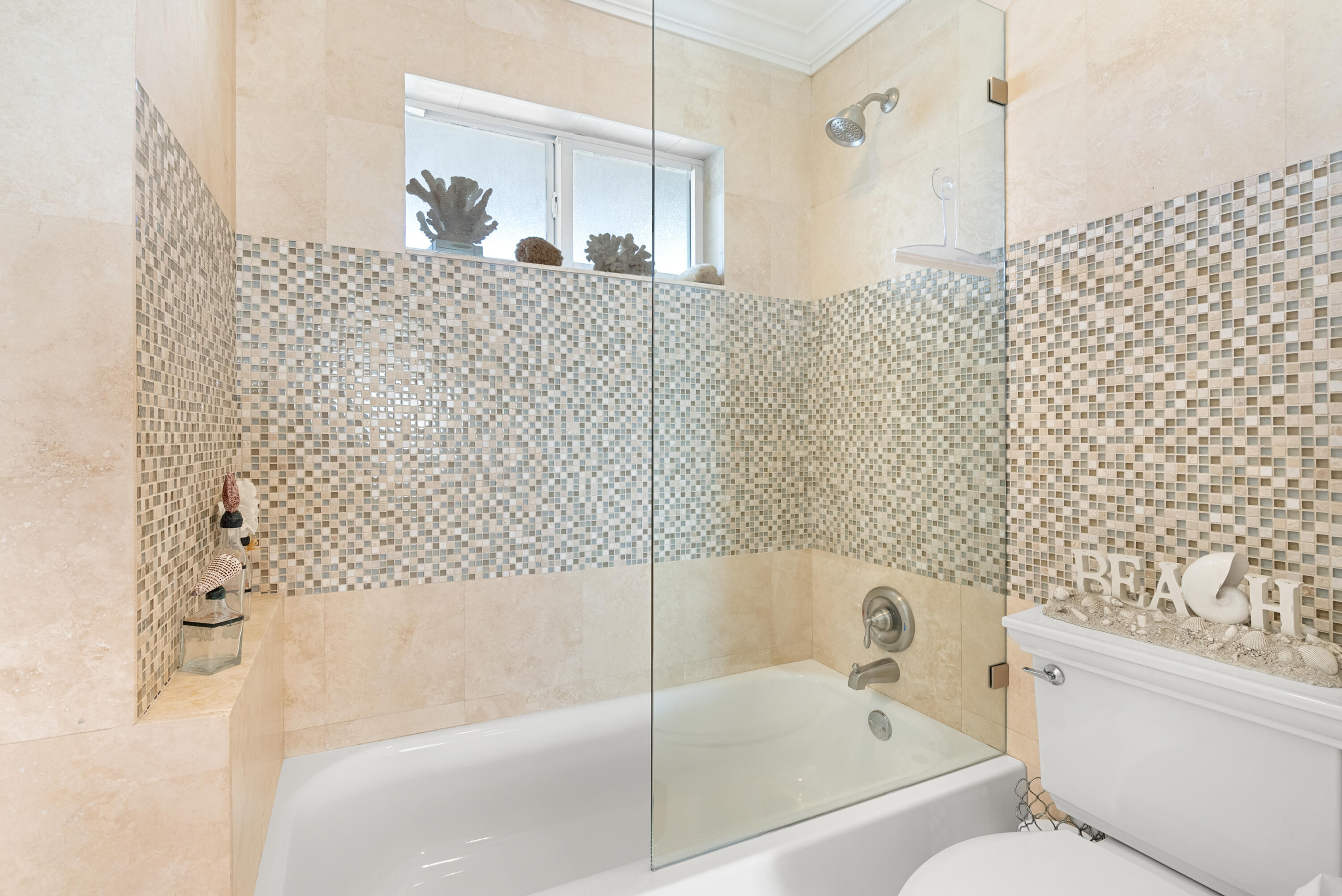 3851 North Ocean Boulevard, Unit 307308 Gulf Stream, FL 33483 - Photo 19 of 26 a bathroom with a bathtub and shower