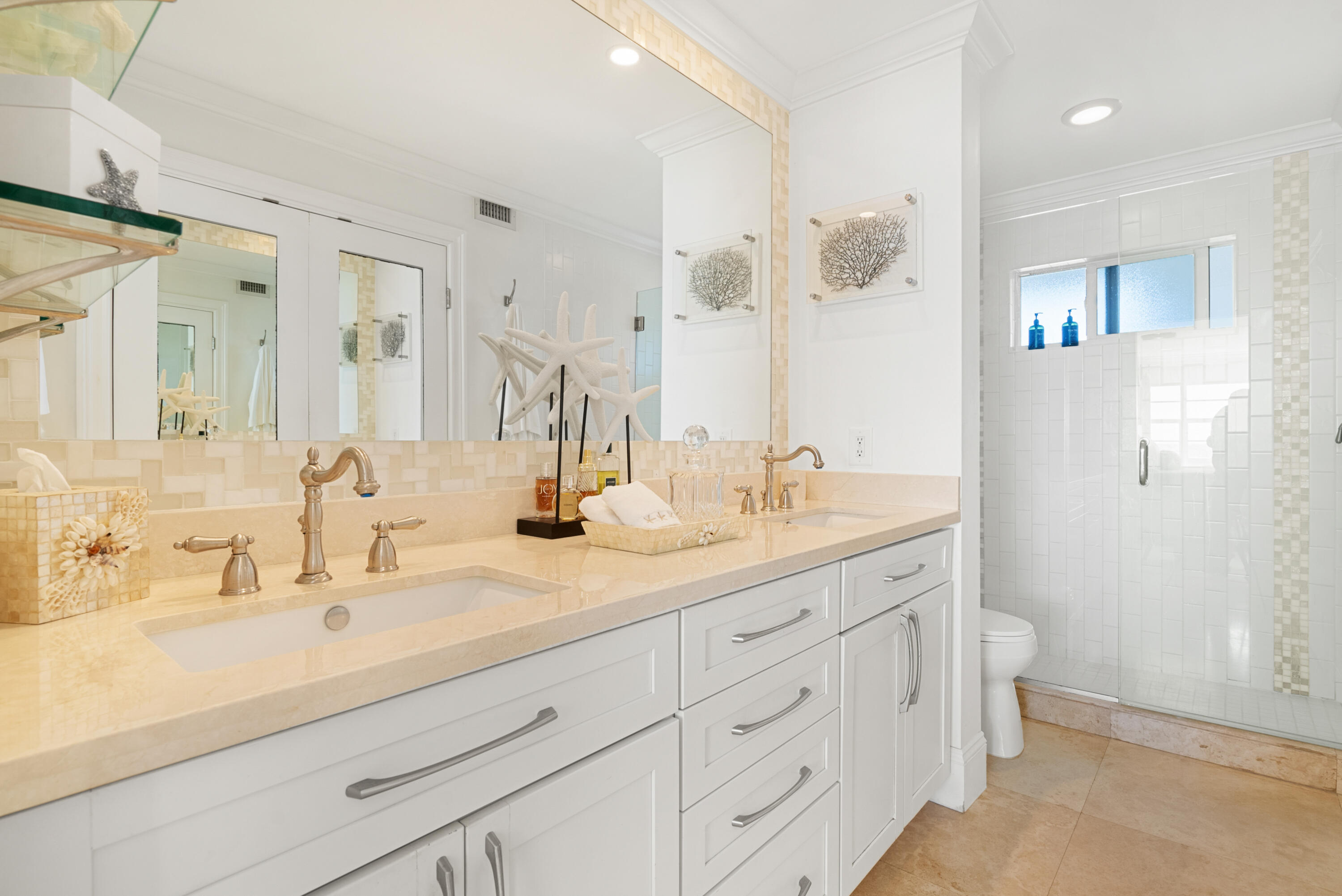3851 North Ocean Boulevard, Unit 307308 Gulf Stream, FL 33483 - Photo 23 of 26 a bathroom with a double vanity sink mirror and toilet
