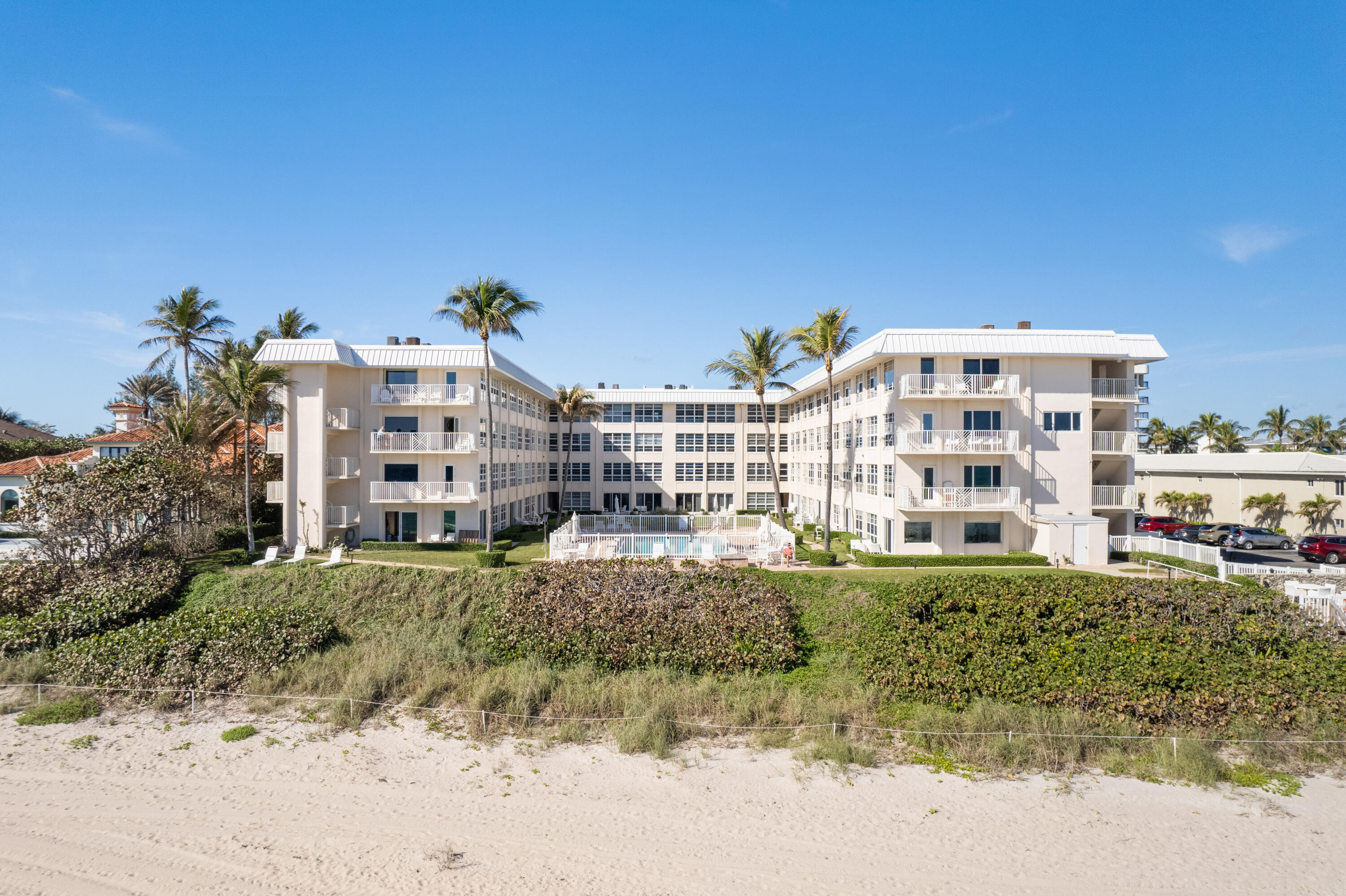 3851 North Ocean Boulevard, Unit 307308 Gulf Stream, FL 33483 - Photo 24 of 26 a view of a large building with a yard
