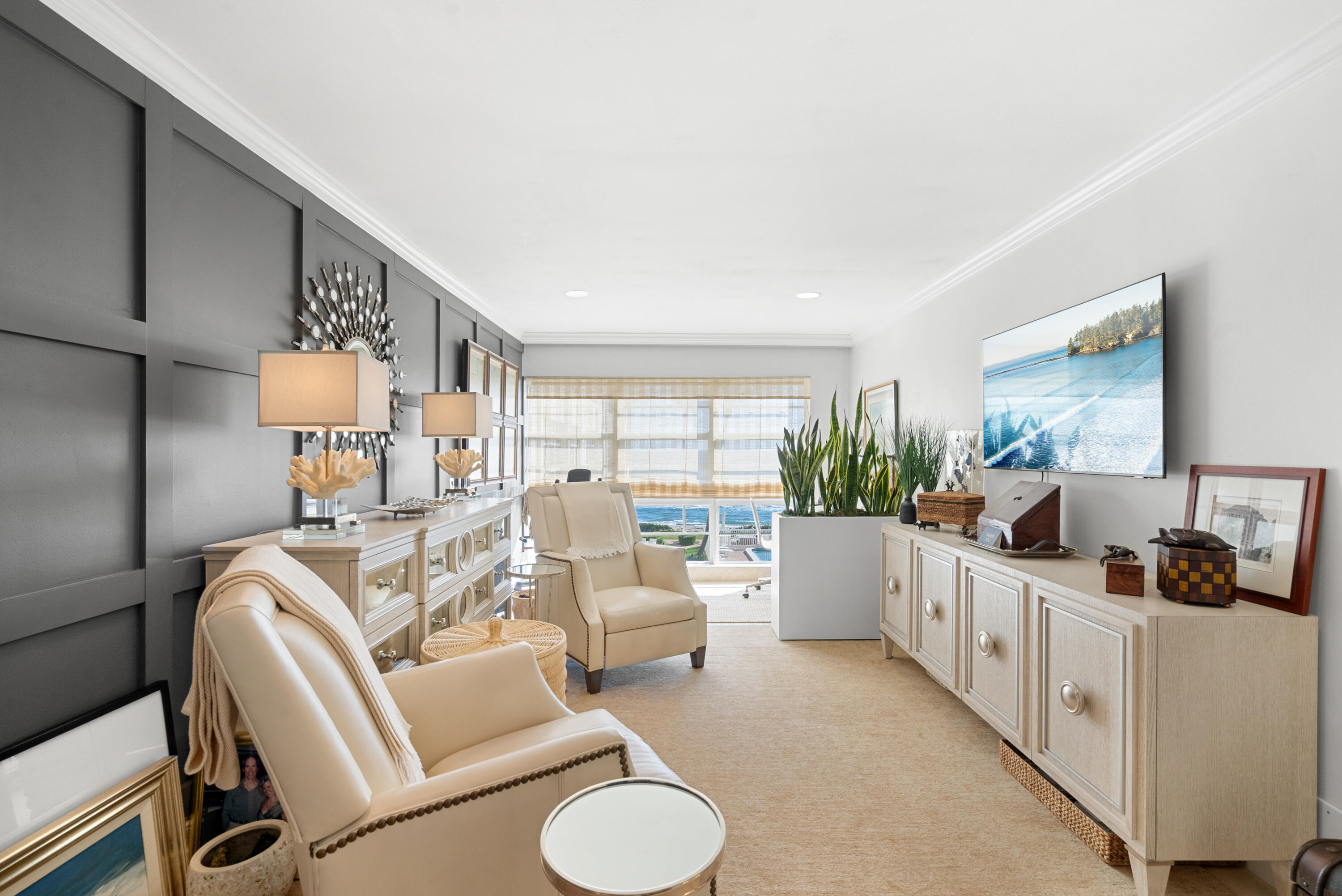 3851 North Ocean Boulevard, Unit 307308 Gulf Stream, FL 33483 - Photo 3 of 26 a living room with furniture and a flat screen tv