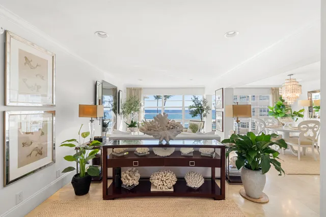 a living room with furniture flowerpot and wooden floor