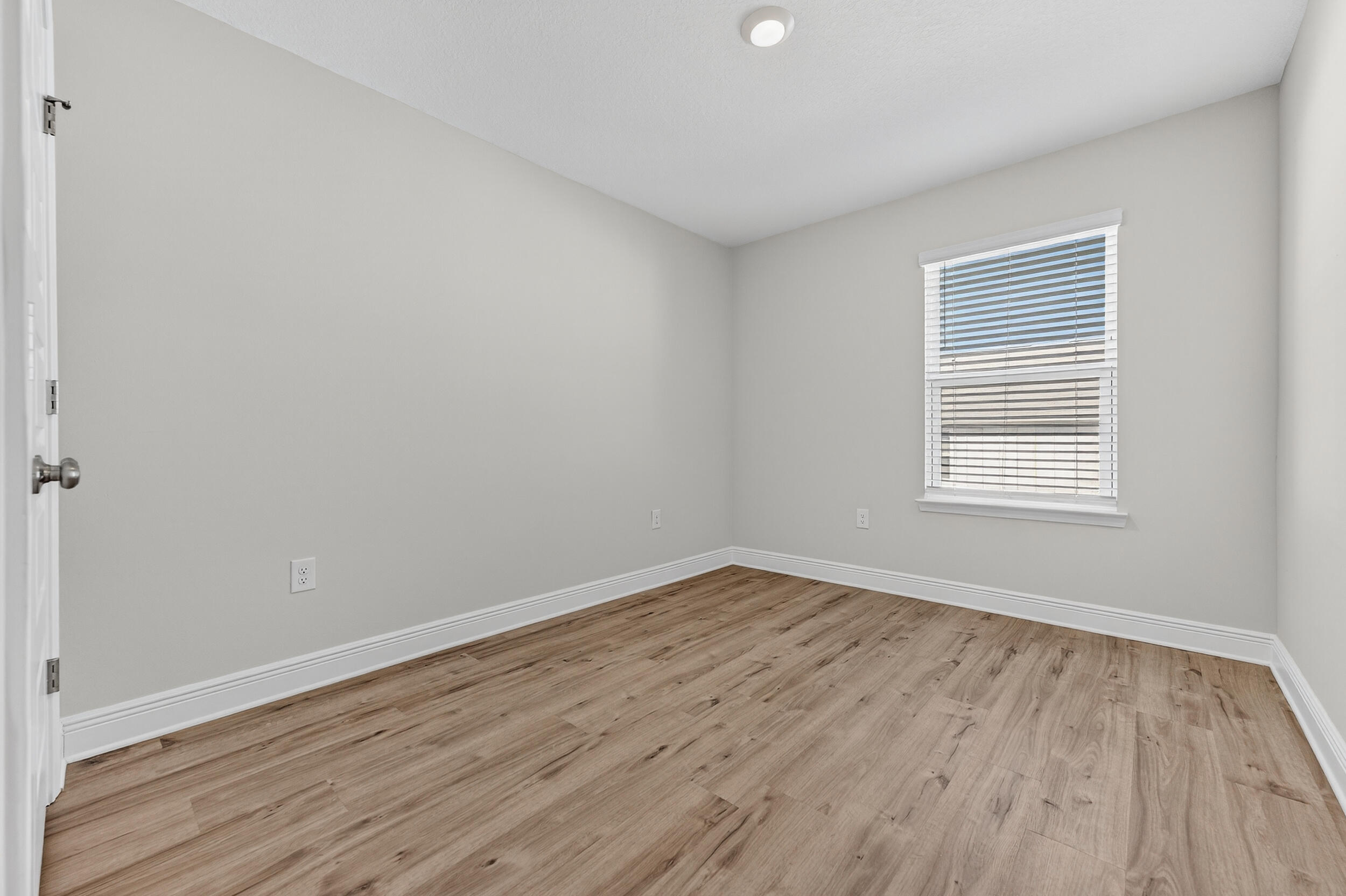 15 Redbird Loop Destin, FL 32541 - Photo 32 of 42 a view of an empty room with wooden floor and a window