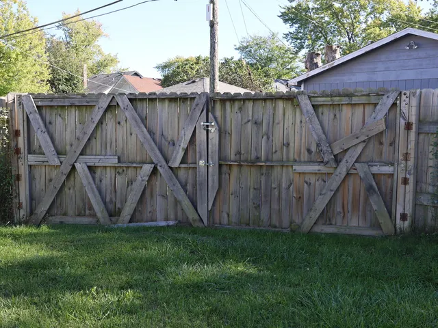 a view of a backyard with a wooden fence
