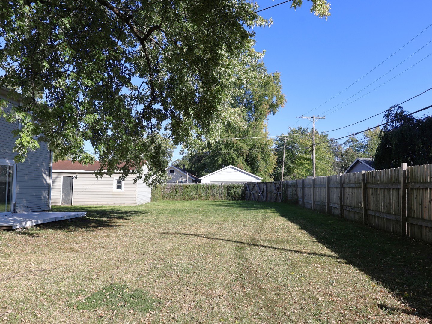 917 North Linden Avenue Waukegan, IL 60085 - Photo 14 of 14 a backyard of a house with table and chairs under an umbrella