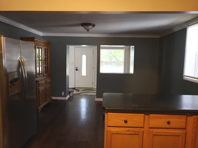a view of a refrigerator in kitchen and wooden floor