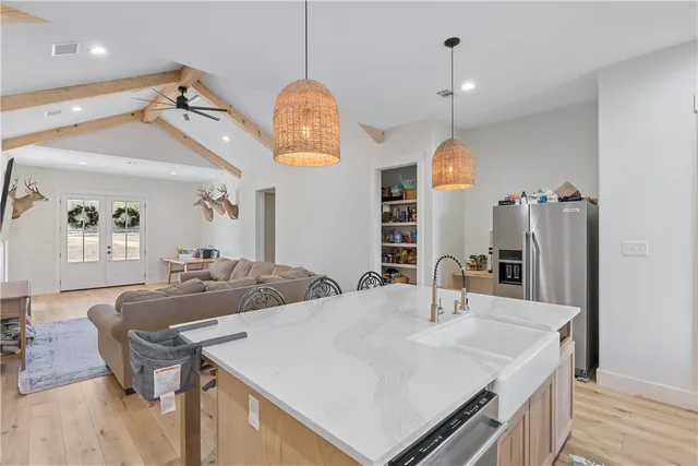a kitchen with sink and refrigerator