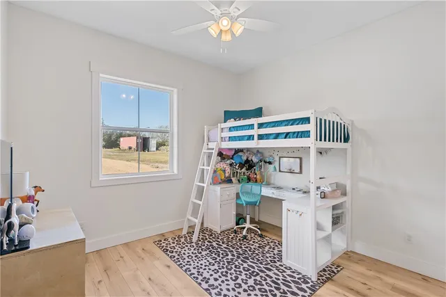 a bedroom with a bed and flat screen tv