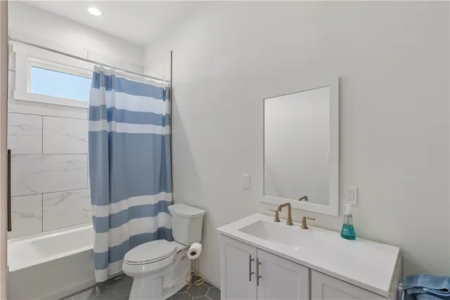 a view of hallway with bathroom and a window