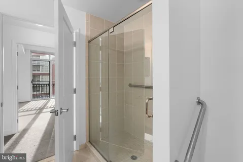 a bathroom with a shower and a glass door