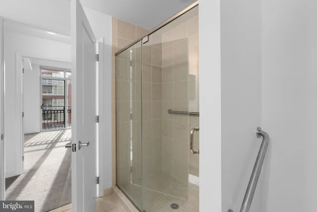 a bathroom with a shower and a glass door