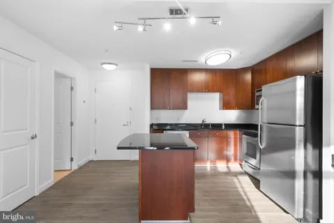 a kitchen with a refrigerator and a sink