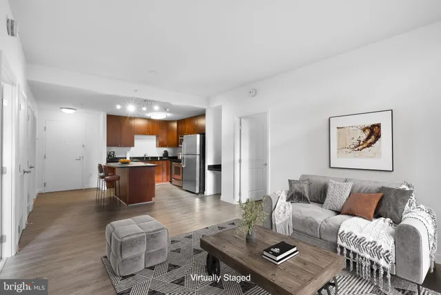 a living room with furniture kitchen view and a table