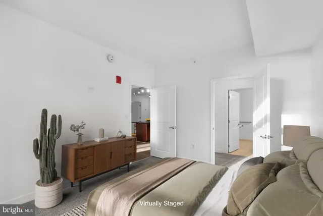 a bedroom with a bed and a potted plant