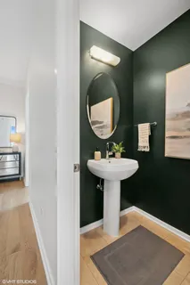 a bathroom with a sink toilet and a mirror