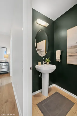 a bathroom with a sink toilet and a mirror
