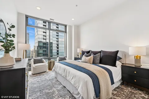 a spacious bedroom with a bed and a couch