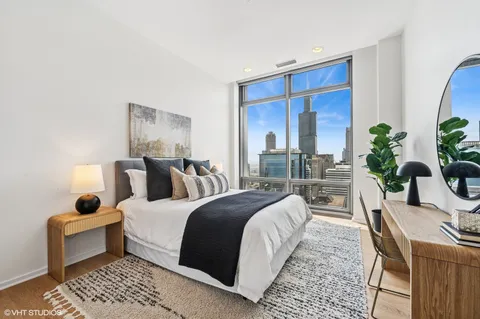 a bedroom with bed and a potted plant