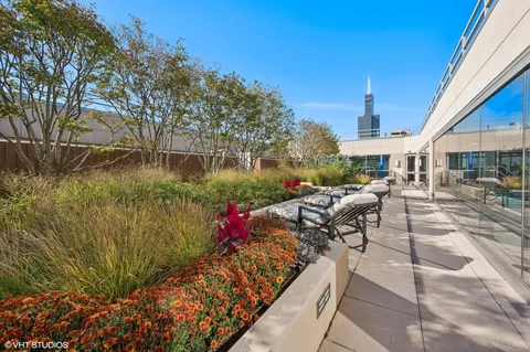 a view of a patio with table and chairs and potted plants