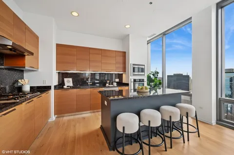 a kitchen with a table chairs stove and cabinets