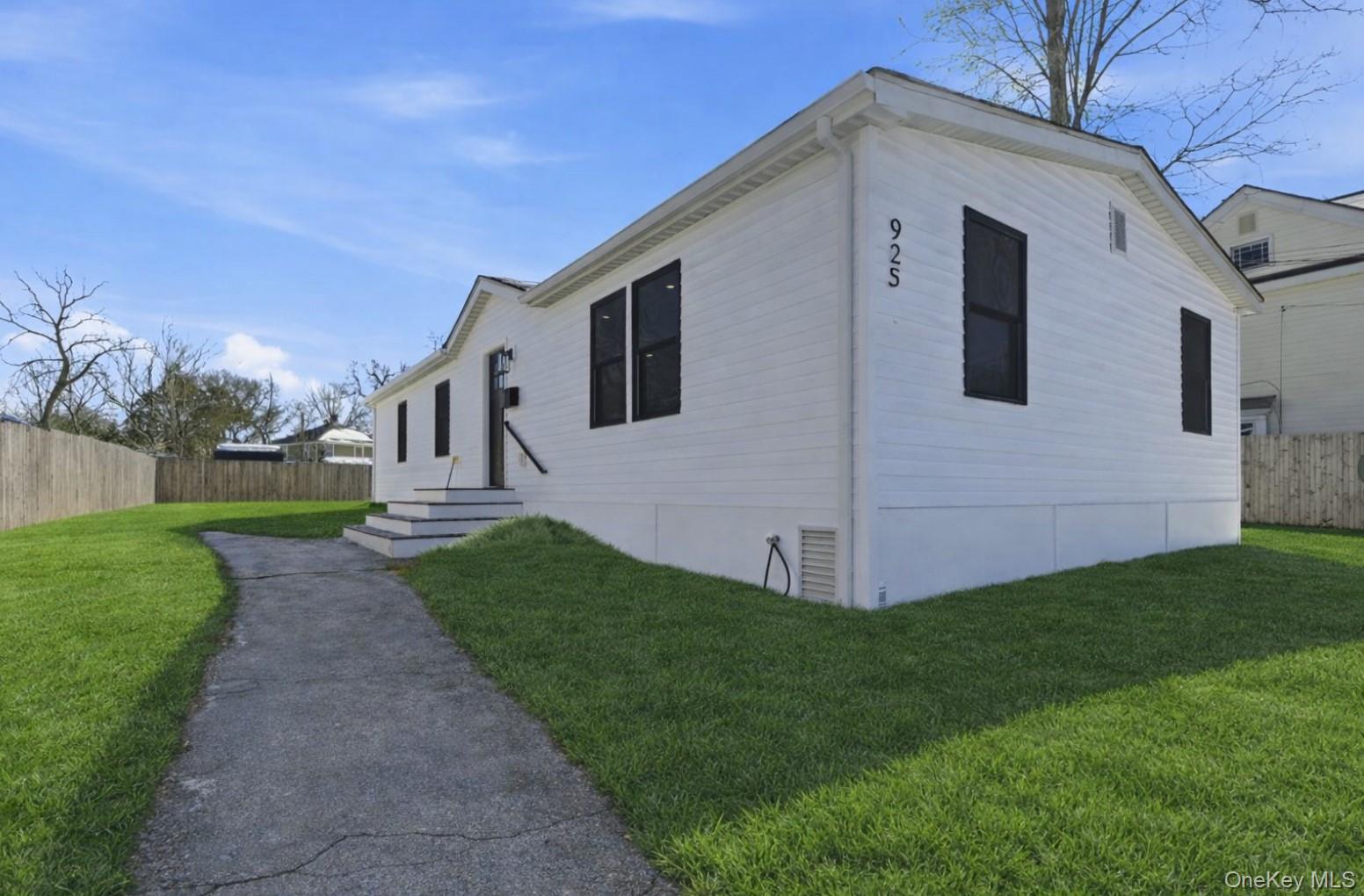 923 East Main Street Riverhead, NY 11901 - Photo 1 of 30 a view of a house with a yard
