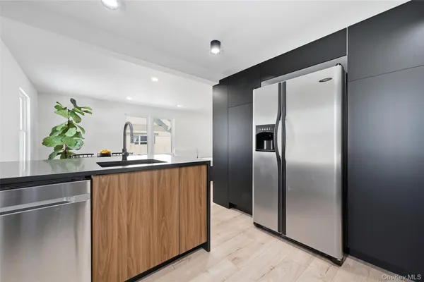 a kitchen with stainless steel appliances a refrigerator and a sink