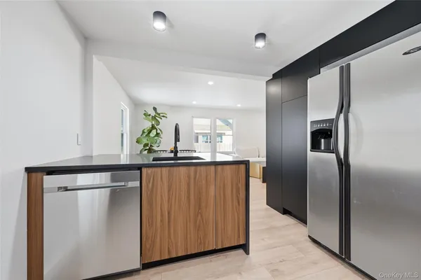 a kitchen with stainless steel appliances a refrigerator and a counter