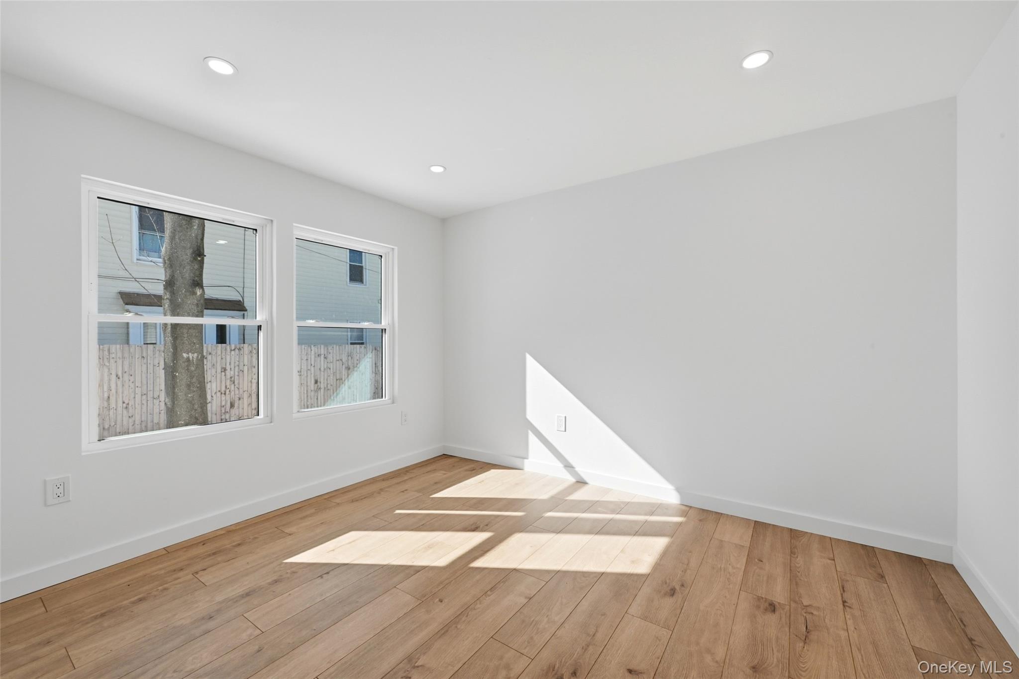 923 East Main Street Riverhead, NY 11901 - Photo 19 of 30 a view of empty room with wooden floor and fan