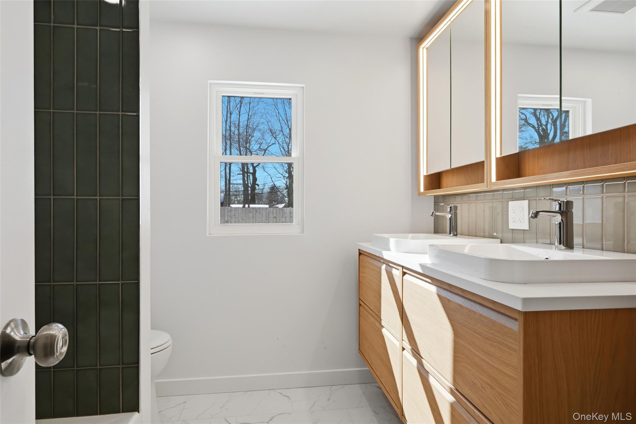 923 East Main Street Riverhead, NY 11901 - Photo 20 of 30 a bathroom with a sink and a mirror