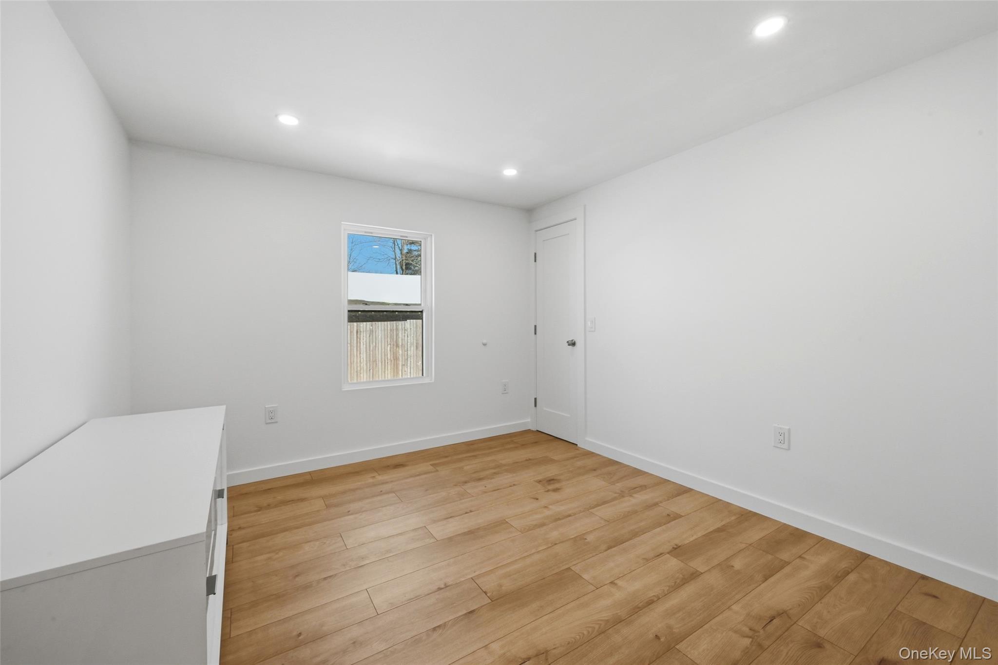 923 East Main Street Riverhead, NY 11901 - Photo 24 of 30 a view of empty room with wooden floor and fan