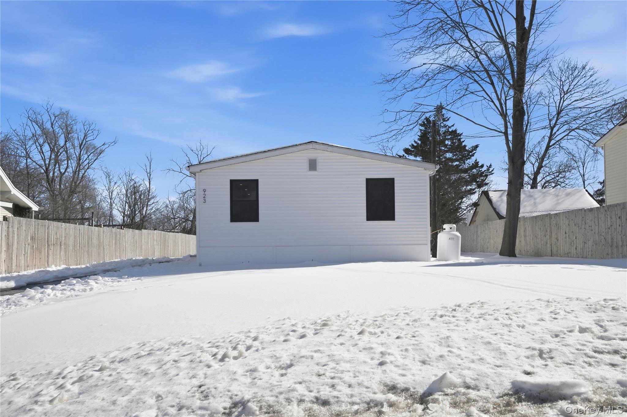 923 East Main Street Riverhead, NY 11901 - Photo 29 of 30 a view of a house with a yard covered in snow