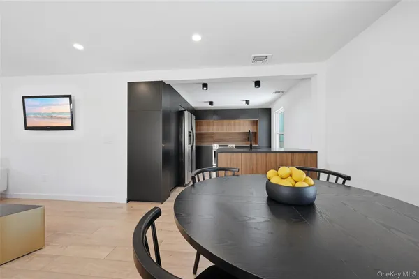 a living room with dining room and wooden floor