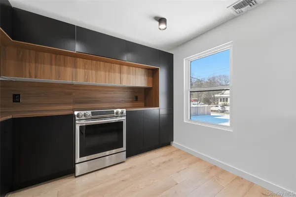 a stove top oven sitting inside of a kitchen