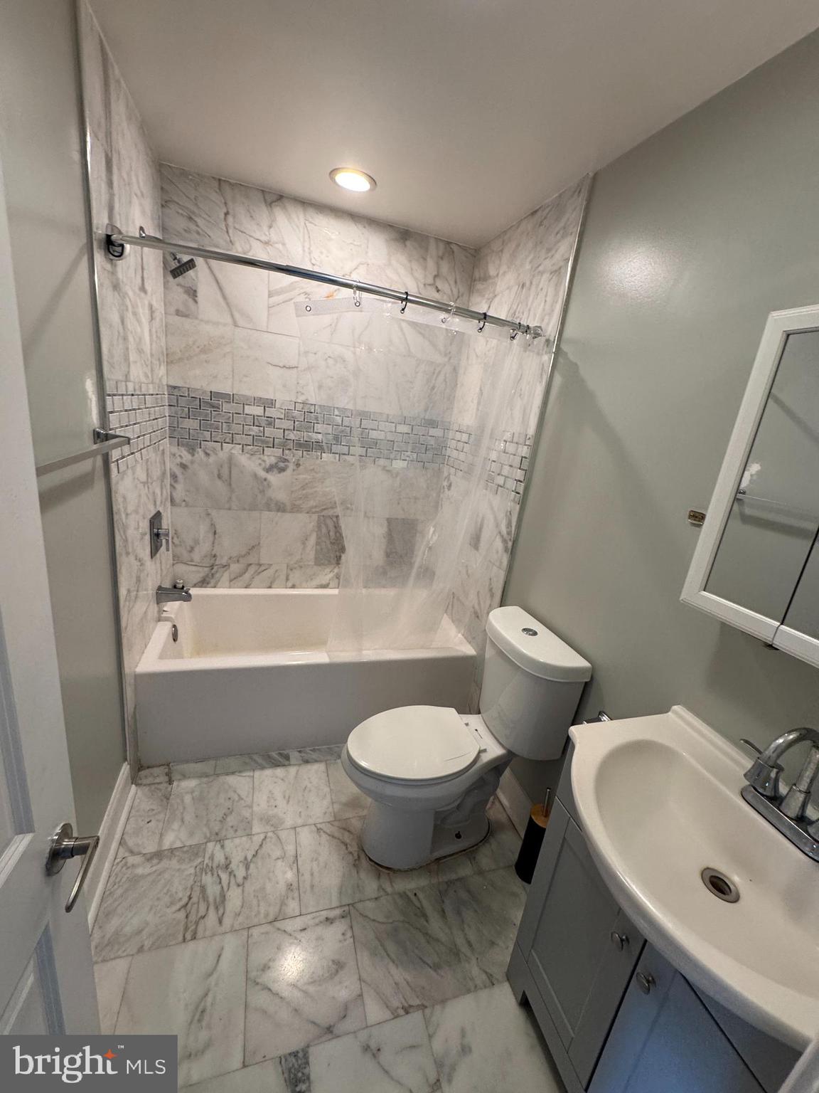 4140 Reisterstown Road Baltimore, MD 21215 - Photo 14 of 18 a bathroom with a sink toilet and shower