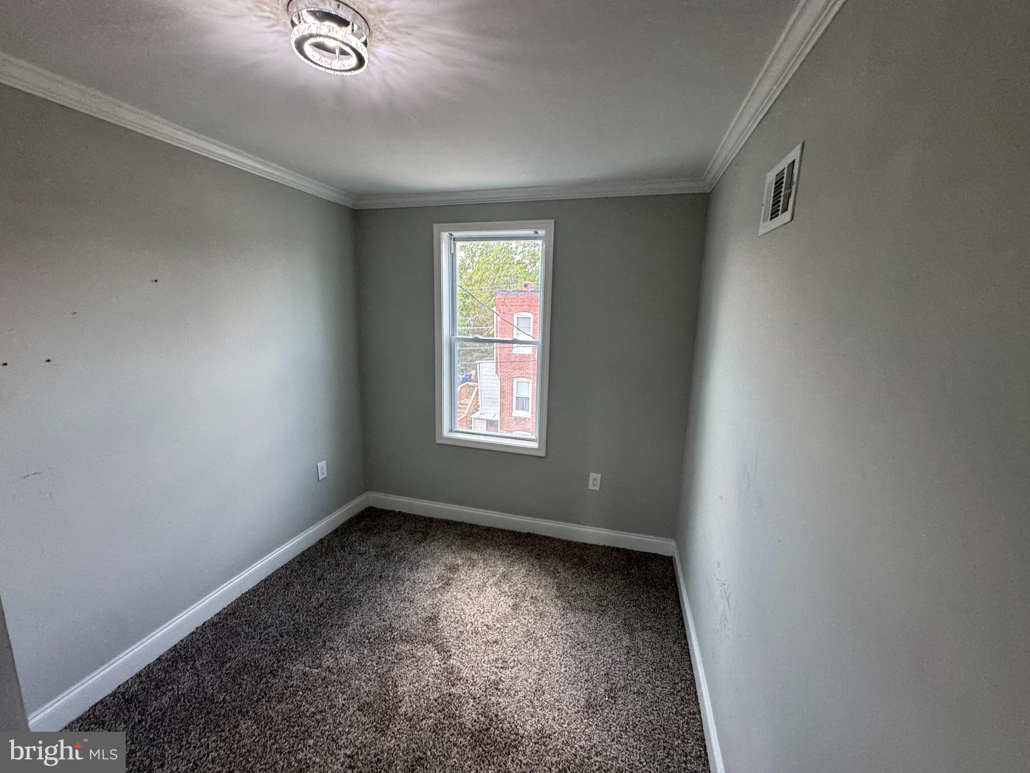 4140 Reisterstown Road Baltimore, MD 21215 - Photo 9 of 18 an empty room with a window