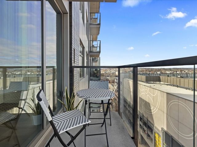 a view of a house with glass windows and a garage