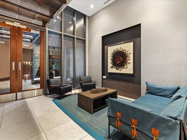 a living room with furniture fireplace and a window