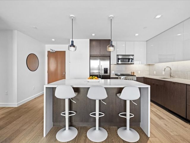 a kitchen with kitchen island granite countertop a table and chairs in it