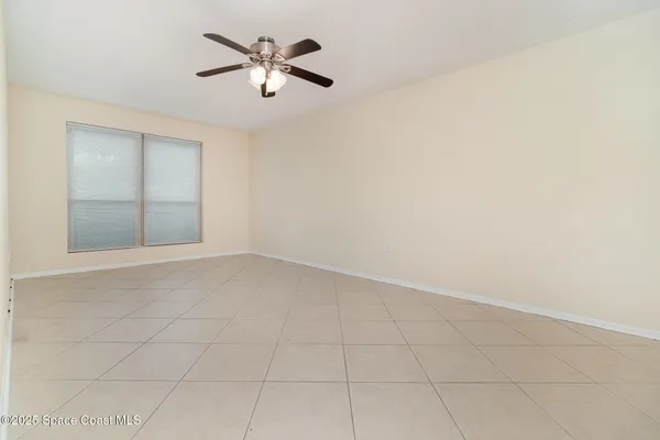 an empty room with a empty space and a ceiling fan
