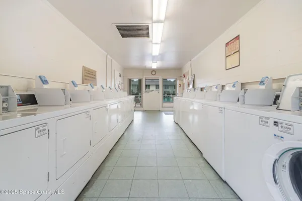 a large white kitchen with cabinets and sink