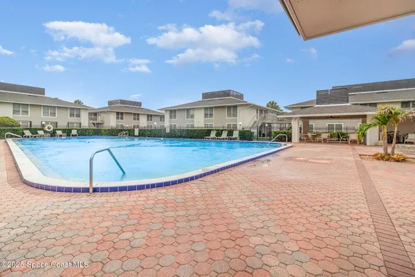 a view of a swimming pool and a yard