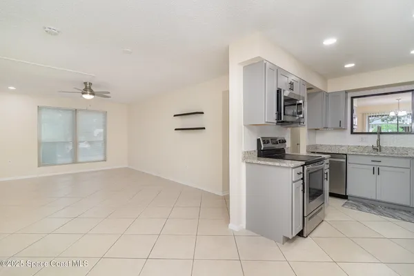 a kitchen with stainless steel appliances granite countertop a sink and cabinets
