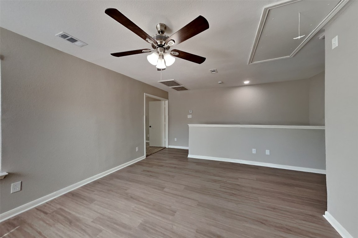 6423 Lily Hollow Court Spring, TX 77379 - Photo 17 of 20 an empty room with wooden floor fan and windows