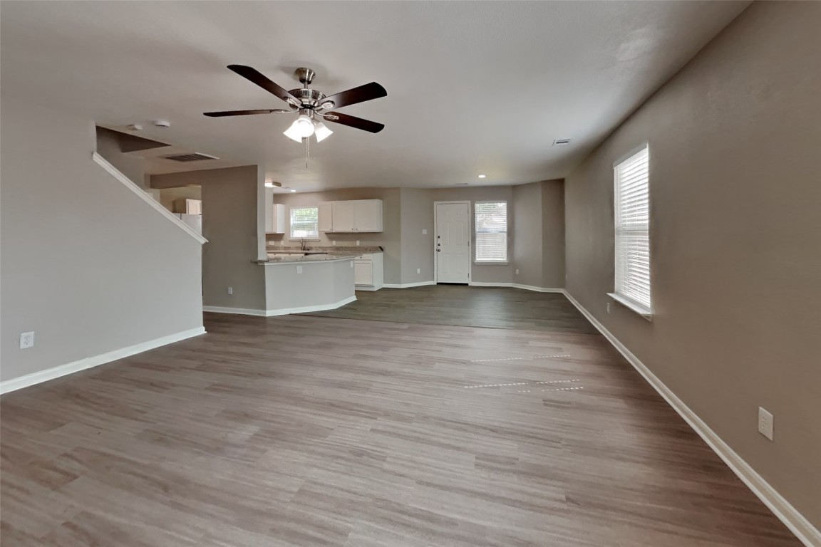 6423 Lily Hollow Court Spring, TX 77379 - Photo 3 of 20 a view of a livingroom with a ceiling fan and wooden floor