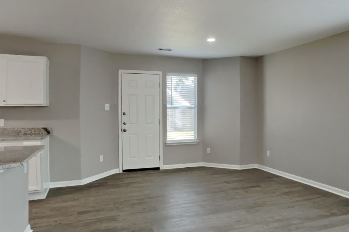 6423 Lily Hollow Court Spring, TX 77379 - Photo 5 of 20 a view of an empty room with wooden floor and a window