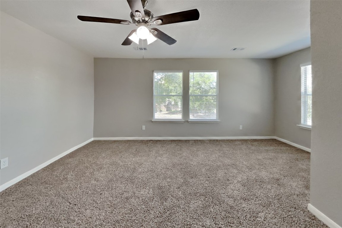 6423 Lily Hollow Court Spring, TX 77379 - Photo 7 of 20 an empty room with a window and a fan