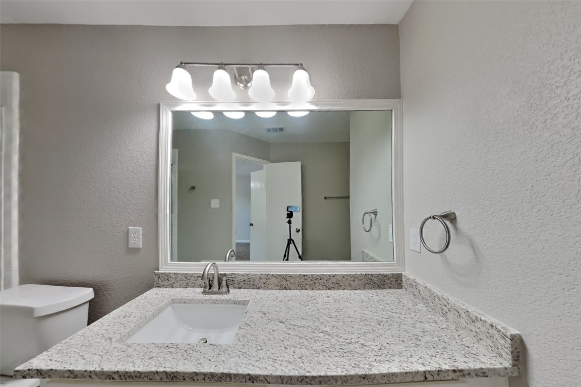 6423 Lily Hollow Court Spring, TX 77379 - Photo 8 of 20 a bathroom with a granite countertop sink and a mirror