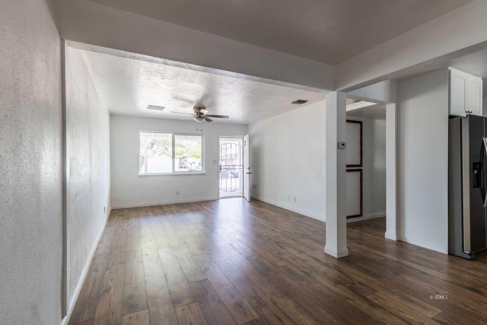 927 West Sullivan Avenue Ridgecrest, CA 93555 - Photo 5 of 24 an empty room with wooden floor and windows